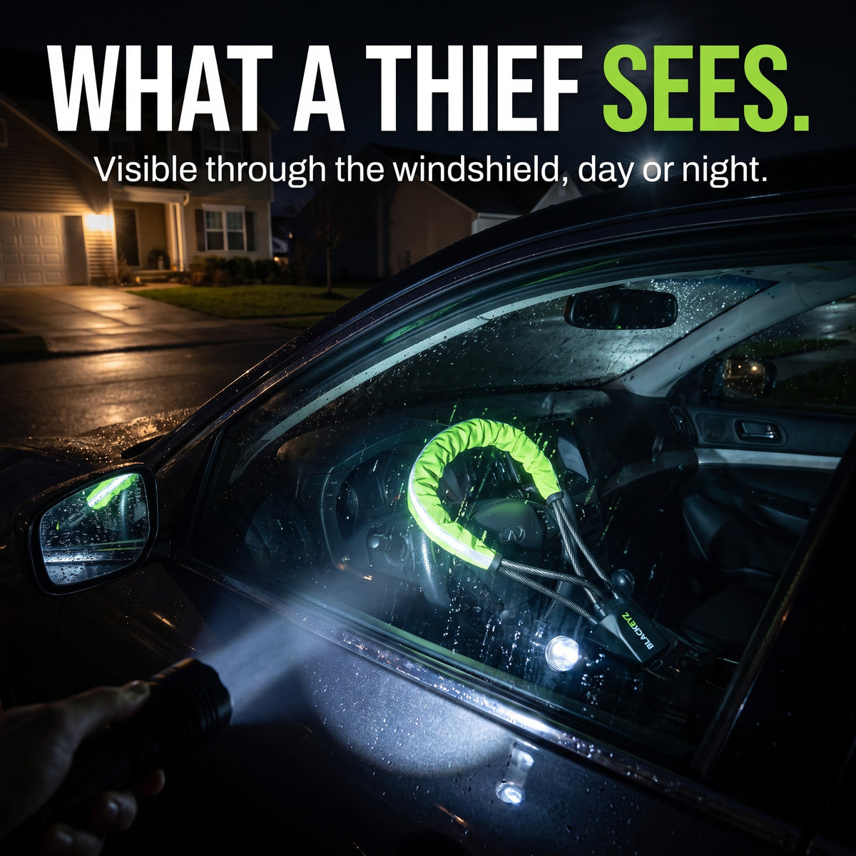 A flashlight reveals the green Steel Lock through the windshield at night